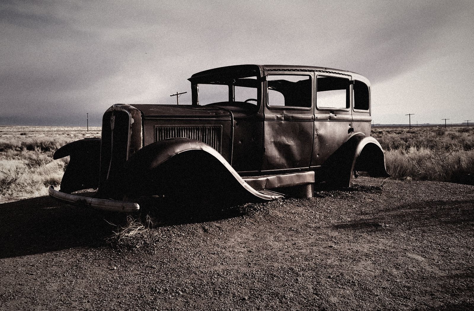Rusted car wreck in the desert