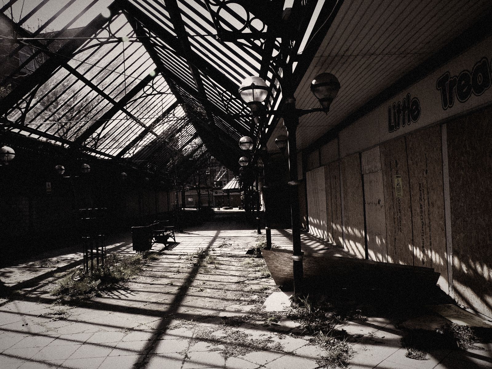 Abandoned shopping mall with boarded-up stores